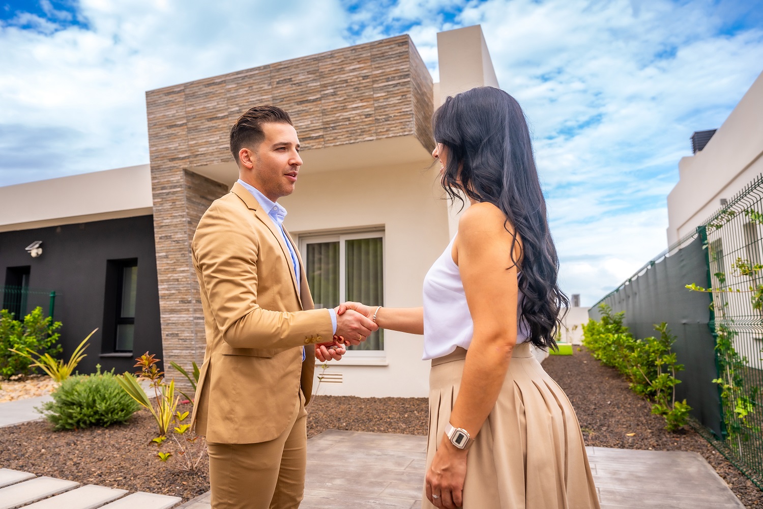 Woman shaking hands to a real estate agent buying a house